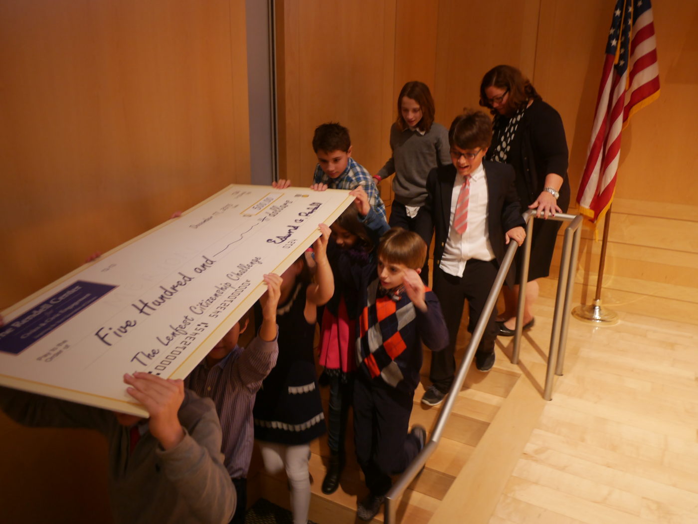 Merion Elementary students carry their winning check.