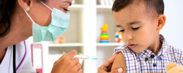 Picture of a doctor administering a vaccine to a child.