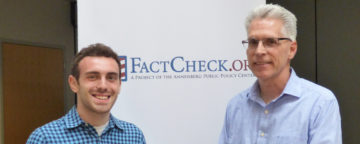 Corey Berman (left), holding the Brooks Jackson Undergraduate Fellowship Award, and FactCheck.org director Eugene Kiely.