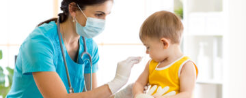 Photo of doctor about to vaccinate a child.