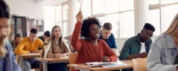 Community college student raising her hand.