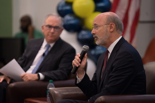 Democratic Gov. Tom Wolfe takes the mic. At left, Philly sports host Michael Barkann.