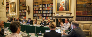 Damian Collins (center-right) speaks in a group meeting in the library. Credit: Silver Apples Photography.