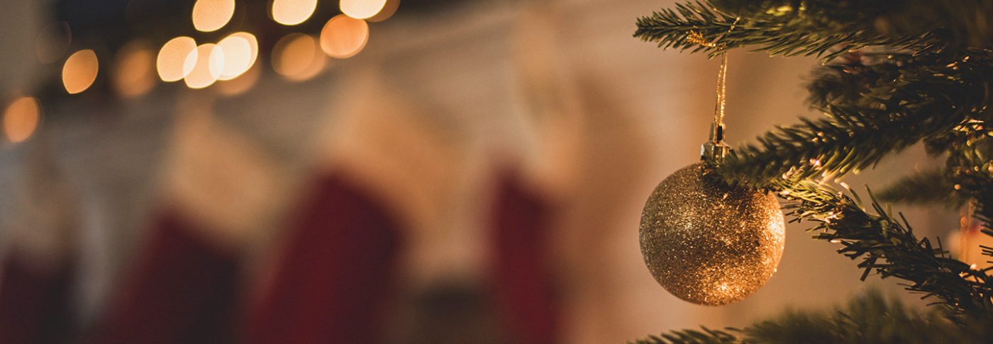 Christmas tree by the fireplace. Credit: Chad Madden/Unsplash.