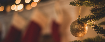 Christmas tree by the fireplace. Credit: Chad Madden/Unsplash.