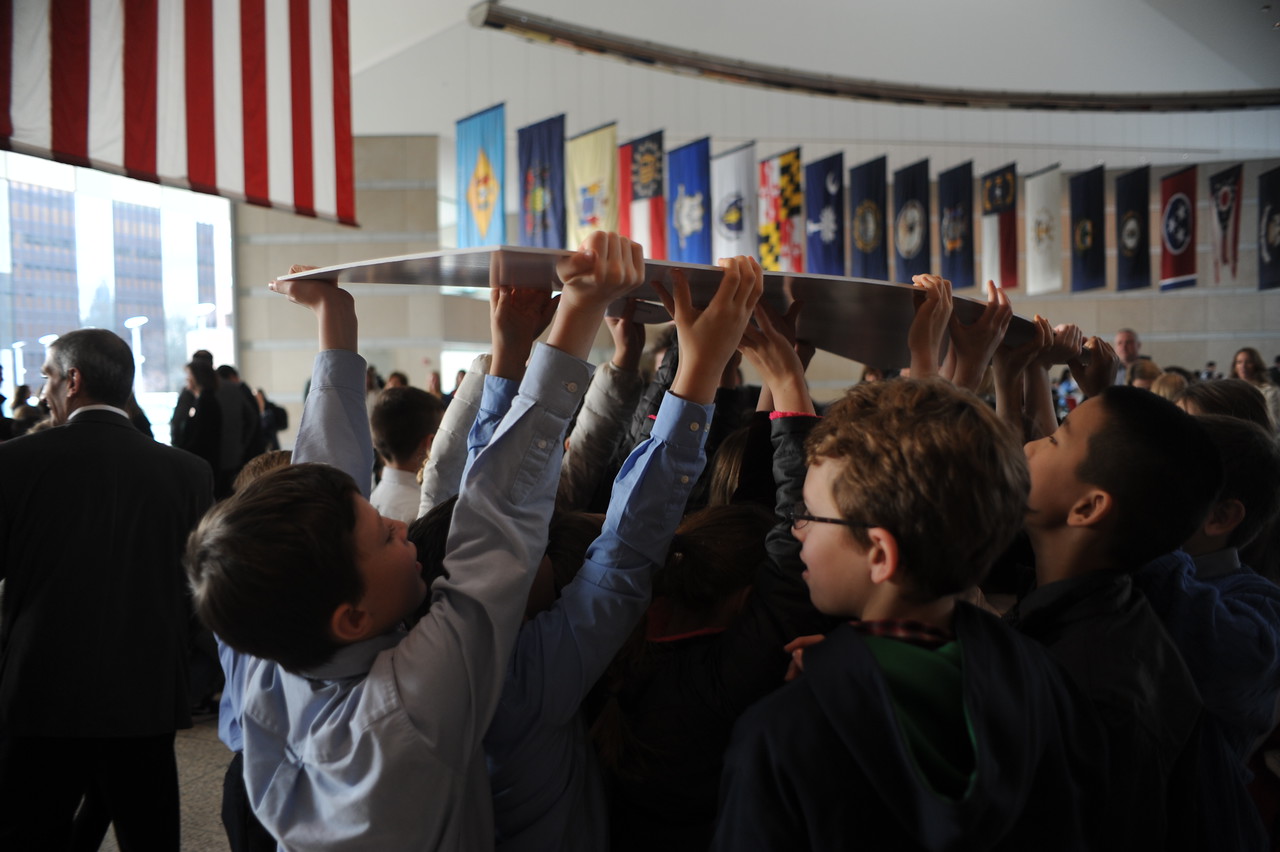 Students carry their class' winning check.