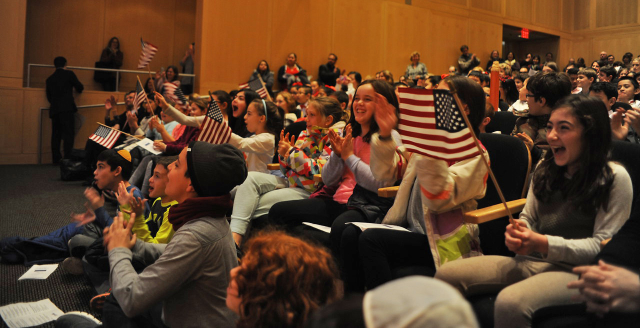 The audience watches the presentations of the Citizenship Challenge finalists.