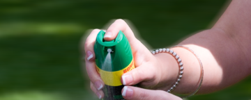 Woman applying mosquito repellent spray. Credit: CDC.