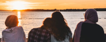 Group of 4 teen girls watching the sunset. Credit: Noorulabdeen Ahmad via Unsplash.