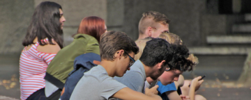 Group of teens on their phones. Credit: Flickr/sc-lover.