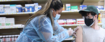 Person receiving vaccine in a drug store.